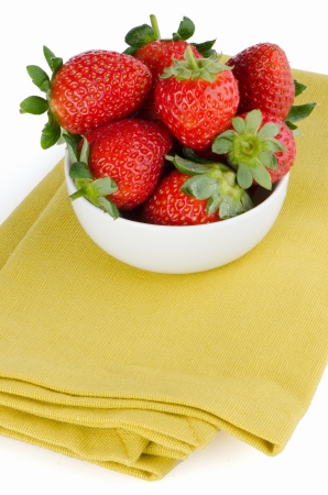 Fresh strawberries in bowl on green towel.の写真素材