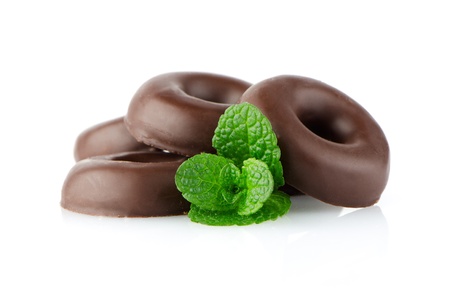 Chocolate donut cookies with green mint leaves on whute background.の写真素材