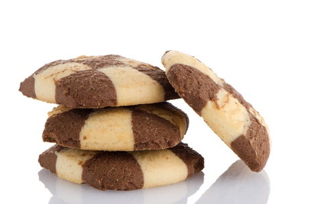 Closeup detail of delicious butter and chocolate cookies on white reflective background.の写真素材