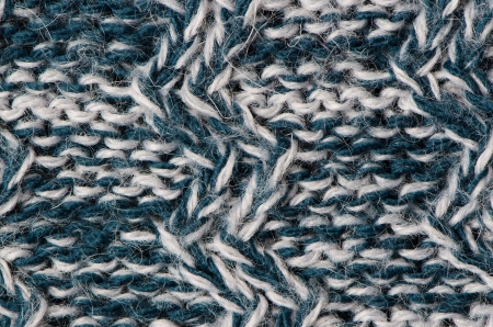 Knit woolen texture. Fabric blue and white background.