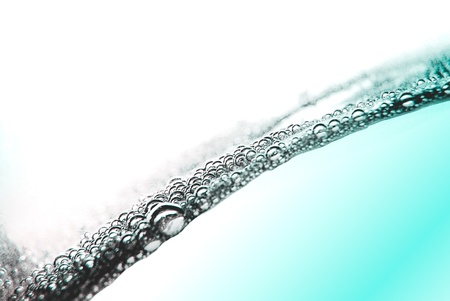Air bubbles in blue water on white background.