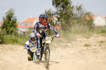 CASTELO BRANCO, PORTUGAL - MAY 5: Aitor Marquez followed by Guilherme Campos at the 3rd stage of the Luso-Spanish BMX race Trophy the on may 5, 2013 in Castelo Branco, Portugal. CASTELO BRANCO, PORTUGAL - MAY 5: Aitor Marquez followed by Guilherme Campos at the 3rd stage of the Luso-Spanish BMX race Trophy the on may 5, 2013 in Castelo Branco, Portugal.