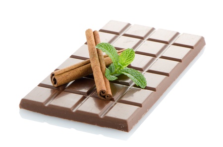 Chocolate bar, mint leaves and cinnamon sticks isolated on white background.の写真素材