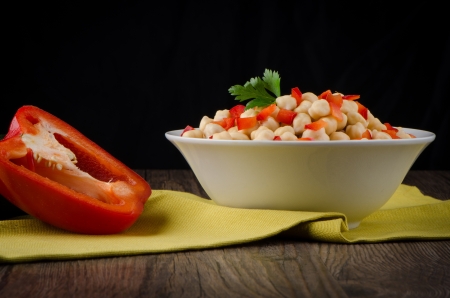 Chickpeas on ceramic bowl on dark wooden background.の写真素材