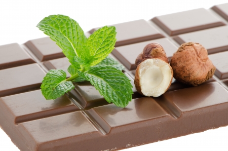 Chocolate Bar with hazelnuts and fresh mint on white backgroundの写真素材