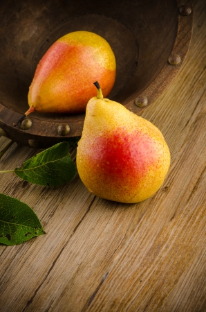 Pears in a Wood Bowl on a wood table.の写真素材
