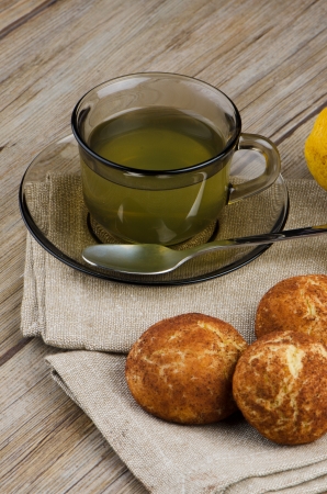 Lemon tea and cookies on wooden table.の写真素材