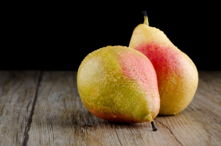 Twho pears in a old wooden table.の写真素材