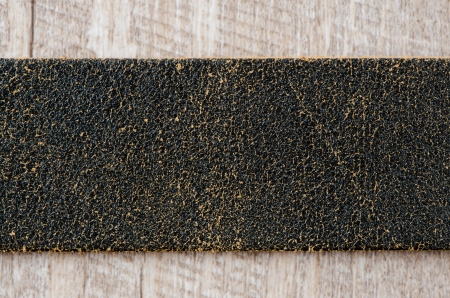 Leather belt over wooden background.の写真素材