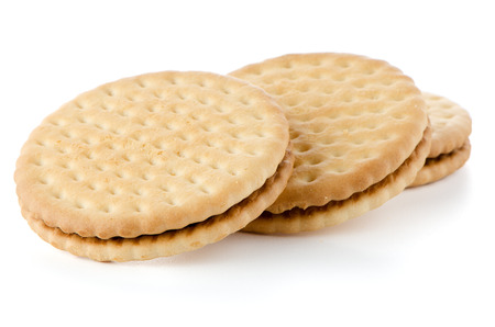 Sandwich biscuits with chocolate filling on a white backgroundの写真素材