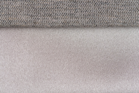 Closeup detail of grey fabric texture background.