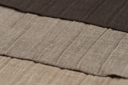 Closeup detail of brown fabric texture background.