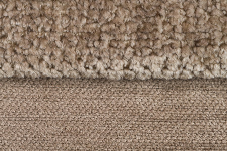 Closeup detail of brown fabric texture background.
