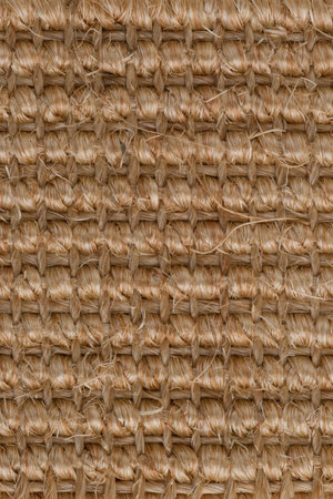 Closeup detail of a brown sisal carpet texture background.