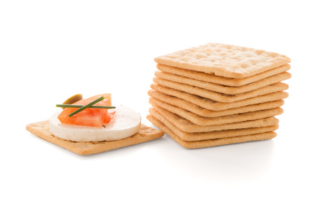 Crackers with cheese and tomato isolated on white backgroundの写真素材