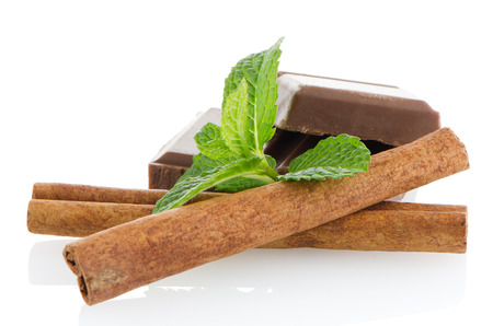 Closeup detail of chocolate parts and mint leaves on white background.の写真素材