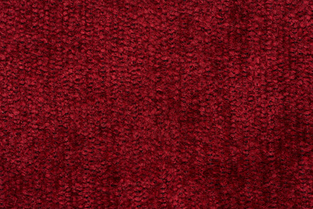 Closeup detail of red fabric texture background.