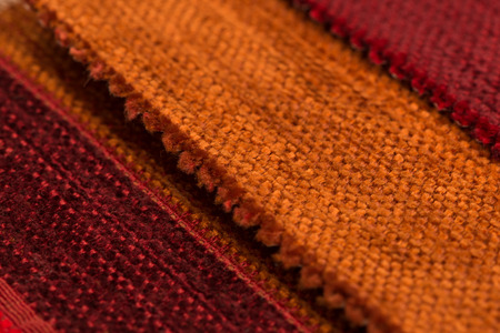 Closeup detail of red fabric texture background.