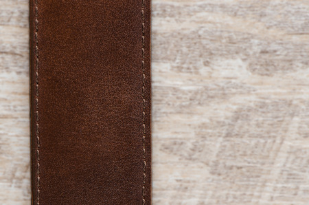 Leather belt over wooden background.の写真素材