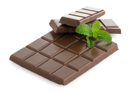Closeup detail of chocolate and mint leaves on white background.の写真素材
