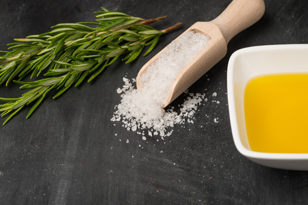Cooking ingredients for mediterranean cuisine - olive oil, bunch of rosemary and salt.の写真素材
