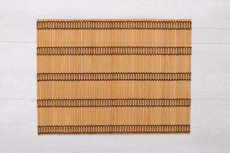 Bamboo place mat on wooden deck table.の写真素材