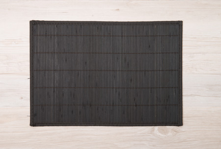 Bamboo place mat on wooden deck table.の写真素材
