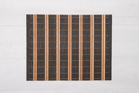 Bamboo place mat on wooden deck table.の写真素材