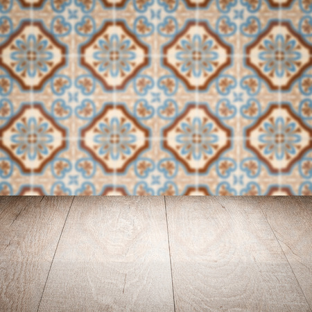 Empty wood table top and blur vintage ceramic tile pattern wall in background, Mock up template for display of your product.の写真素材