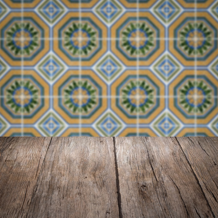 Empty wood table top and blur vintage ceramic tile pattern wall in background, Mock up template for display of your product.の写真素材