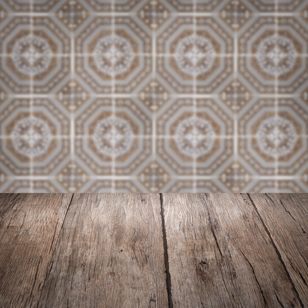 Empty wood table top and blur vintage ceramic tile pattern wall in background, Mock up template for display of your product.の写真素材