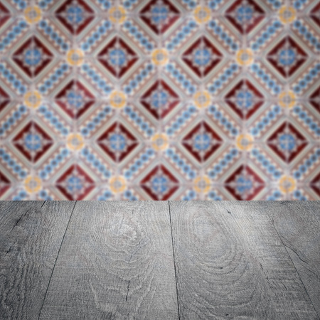 Empty wood table top and blur vintage ceramic tile pattern wall in background, Mock up template for display of your product.の写真素材