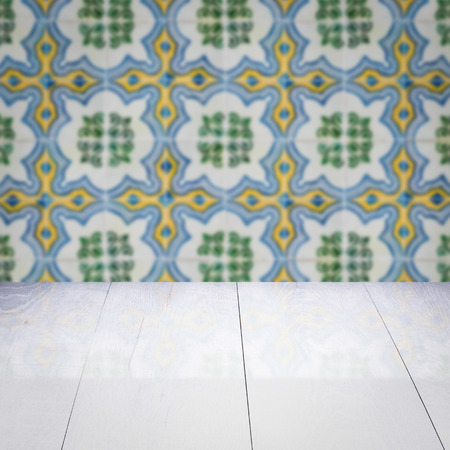 Empty wood table top and blur vintage ceramic tile pattern wall in background, Mock up template for display of your product.の写真素材