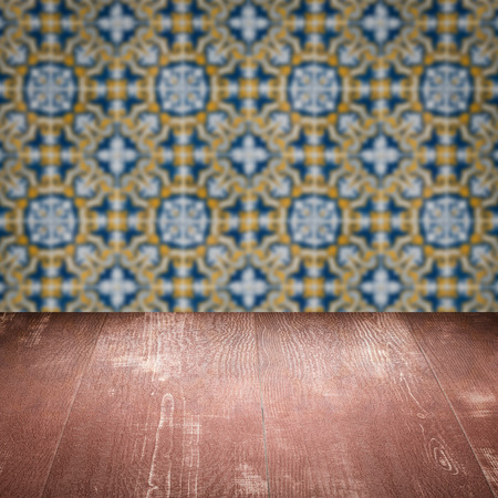 Empty wood table top and blur vintage ceramic tile pattern wall in background, Mock up template for...