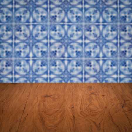 Empty wood table top and blur vintage ceramic tile pattern wall in background, Mock up template for display of your product.の写真素材