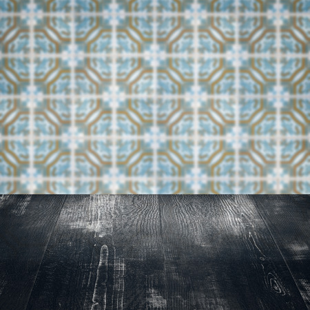 Empty wood table top and blur vintage ceramic tile pattern wall in background, Mock up template for...