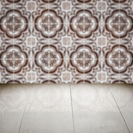 Empty wood table top and blur vintage ceramic tile pattern wall in background, Mock up template for display of your product.の写真素材