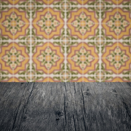 Empty wood table top and blur vintage ceramic tile pattern wall in background, Mock up template for display of your product.の写真素材