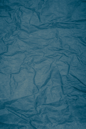 Closeup detail of blue crumpled paper texture with white frame.の写真素材