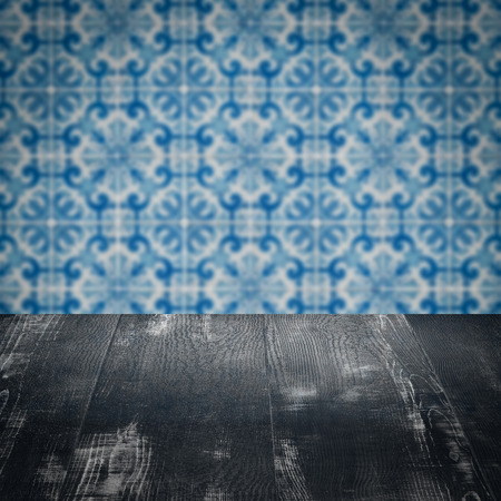 Empty wood table top and blur vintage ceramic tile pattern wall in background, Mock up template for display of your product.の写真素材