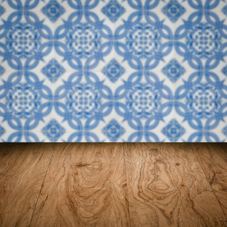 Empty wood table top and blur vintage ceramic tile pattern wall in background, Mock up template for display of your product.の写真素材