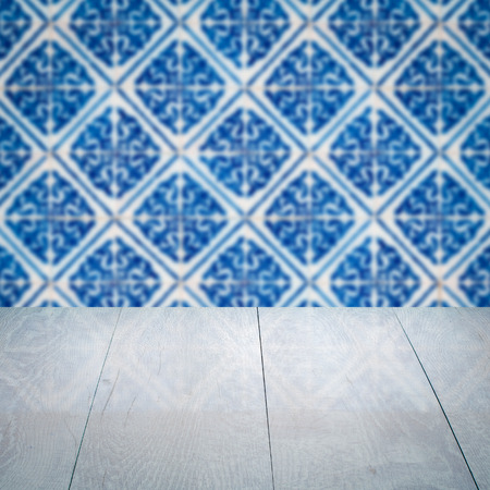 Empty wood table top and blur vintage ceramic tile pattern wall in background, Mock up template for display of your product.の写真素材