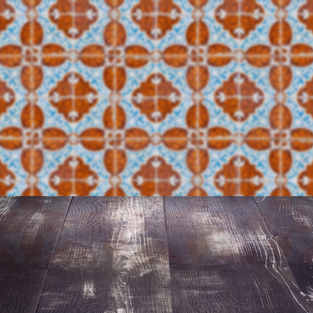 Empty wood table top and blur vintage ceramic tile pattern wall in background, Mock up template for display of your product.の写真素材