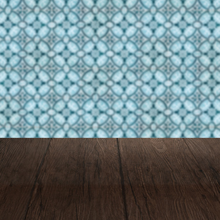 Empty wood table top and blur vintage ceramic tile pattern wall in background, Mock up template for...