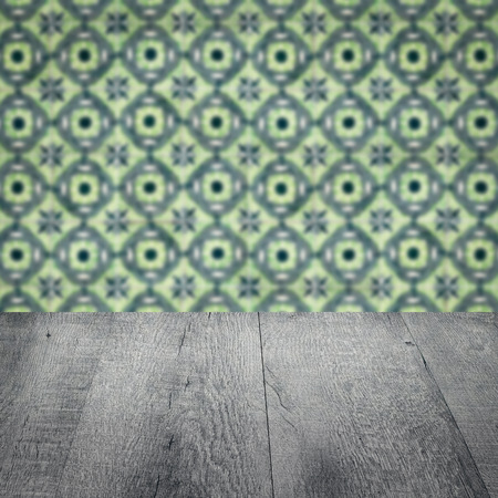 Empty wood table top and blur vintage ceramic tile pattern wall in background, Mock up template for display of your product.の写真素材