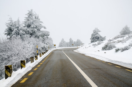 Mountain road with white snow.の写真素材