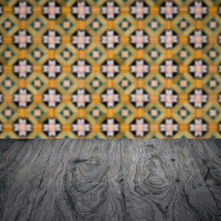 Empty wood table top and blur vintage ceramic tile pattern wall in background, Mock up template for display of your product.の写真素材