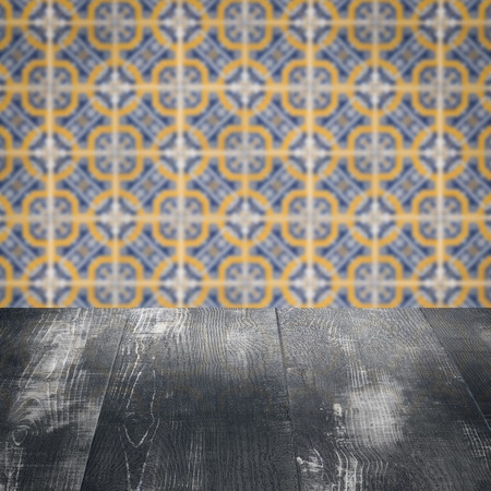 Empty wood table top and blur vintage ceramic tile pattern wall in background, Mock up template for...