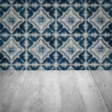 Empty wood table top and blur vintage ceramic tile pattern wall in background, Mock up template for display of your product.の写真素材