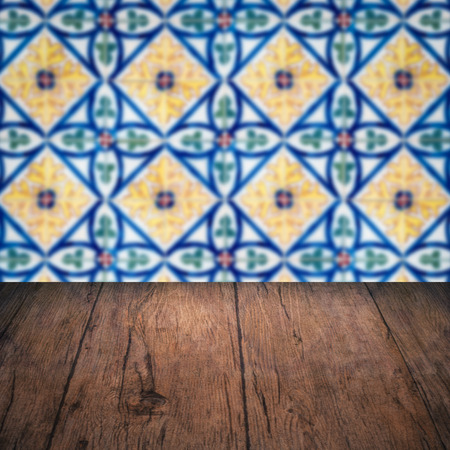 Empty wood table top and blur vintage ceramic tile pattern wall in background, Mock up template for display of your product.の写真素材